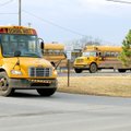 School buses leave after school from near the school Administration Office Tuesday in Decatur. Contr...