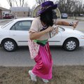 MONKEYING AROUND
Sandra Barth of Fayetteville waves Tuesday to passing motorists on South Eighth St...
