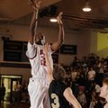 Springdale High senior forward T.J. Andrews takes a shot over Bentonville senior guard Grant Higgins...
