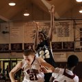 Bentonville sophomore guard Mytaah Crawford shoots Springdale High senior forward Joseph Kellogg, ce...