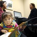  
Amy Garcia, 3, flips through a coloring book while her mother, Idania Valadez (cq) (left), both o...
