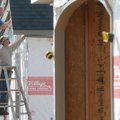 Dan May, above, and Heath Whitley, both with Whitley Construction of Bella Vista, install trim Wedne...
