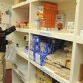 Daphne Harrington with the Village Bible Evangelical Free Church Food Pantry grabs some peanut butte...