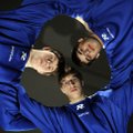 Brothers Brandon, 16, left, Nick, 15, and Thomas Mulcahy, 18, wrestle together on Rogers High School...