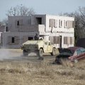 Smoke wafts across the fictional Carnis Village at Fort Chaffee on Wednesday as personnel from one H...