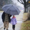 WET WALK
Juliana Sepeda, 3, walks Thursday with Maria Cervantes, left, on a rainy afternoon in Spri...