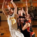 Gravette senior David O’Brien, right, and senior Nick Hendren reach to block a shot by Prairie Grove...