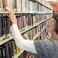 Jane E. Johnson looks for the right place Friday for a book at the Bella Vista Library. Johnson is a...