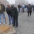 BEAUTIFICATION PROJECT - John Ford, from left, Beth Guest, and Sara Ford look at an emblem Friday fo...