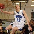 Rogers junior forward Graham Parker shoots over Springdale High’s Curtis Evans in the first half Fri...