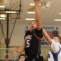 Springdale High’s Tony Dennis shoots in front of a Rogers High defender during the second half Frida...