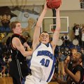 Rogers guard Josh Anderson, center, grabs a rebound in front of Springdale’s Evan Johnson, left, and...