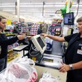 DEBIT OR CREDIT? - Kari Miller, left, makes a purchase with her Debit card from cashier LaDonna Stev...