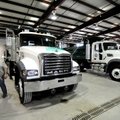 Alan Stacy, a Washington County Roads Department employee, walks Tuesday near four new trucks.