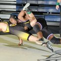 Fayetteville’s Devin Bowers, right, locks onto to a leg during his victory over Missouri Diamond’s X...