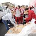 University of Arkansas student-athletes help load boxes of food from Tyson Foods Inc. while particip...