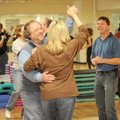 Dance instructor Mike Evans, right, works with John Ervin, left, and Carolyn Long during a swing dan...