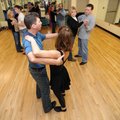 Couples receive help from dance instructors Mike Evans and Millie Sanabria-Terry during a swing danc...