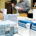 Dr. Lance Faddis looks through medical supplies Saturday at the First Baptist Church in Rogers while...