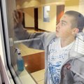 SHINE ON - Volunteer Blake Smith cleans the windows Saturday surrounding the ice skating rink at the...