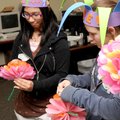 PAPER JESTERS - Chatchalita Klatalumbon, 15, left, and Karen Shelton, 16, make paper flowers Saturda...