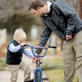 AN IMPORTANT STEP - Caleb Coleman, 4, climbs aboard his Spider-Man bicycle after his father, John Co...
