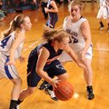 Fayetteville Woodland’s Sarah Smith, left, and Sydney Trumbo, right, pressure Rogers Heritage’s Cour...