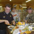 Aaron Jolliff, owner of Hook, Line and Sinker in Rogers, spices up a bowl of chili Friday while dini...