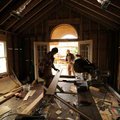 Ron Pendley and his son, Pete, of Pendley Construction in Rogers work Monday to reconstruct the west...