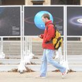 Brandon Trantham, a University of Arkansas sophomore from Springfield, Mo., walks past photographs o...