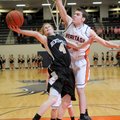 Bentonville guard Tyler Haggard shoots a layup while guarded by Rogers Heritage center Nick Jordan o...