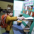 PREFLIGHT CHECK - Charlie Borgsmiller adjusts his science fair project Tuesday at Vandergriff Elemen...