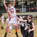 Rogers Heritage guard Nick Jordan grabs a rebound against Bentonville on Tuesday in Rogers.
