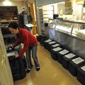 Krissi Beeks, program assistant at the Fayetteville Senior Center, loads meals Wednesday for Meals o...