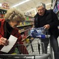 Earl and Doris Friesen of Garfield shop for supplies Wednesday at Harps Food Store in Rogers while p...