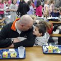 Brian Preece and son Keaton Preece, 7, eat lunch together Wednesday during Lunch with Dad at Walker ...