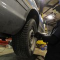 Tony Anderson, mechanic with the Springdale Police Department, attaches the lug nuts onto a studded ...