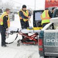Bentonville Fire Chief Dan White, left, helps paramedics prepare to remove an injured man from his v...