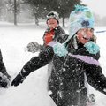 Halle Disney, 7, right, gets hit by a snowball from her brother Connor, 11, center, as the two and J...