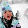 Halle Disney, 7, is hit by a snowball from her brother Connor, 11, right, as the two and Jaylen Stew...