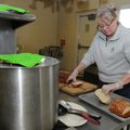 Jean Mentzer, director of the Salvation Army Emergency Shelter in Bentonville, slices bread Friday, ...