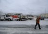 Donald Pinkley, safety coordinator for Ozarks Electric Cooperative, walks through the staging yard at their Fayetteville office Friday Jan. 29. The company has brought in crews from neighboring states to handle power outages that may arise.