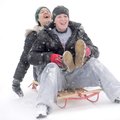 Carley Treat, left, and Katie McNelly laugh while sledding down East Spring Street Friday, Jan. 29 i...