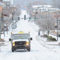 A Fayetteville Transportation Division truck spreads brine onto West Dickson Street Friday, Jan. 29 ...