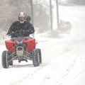 A all-terrain vehicle heads east up East Spring Street Friday, Jan. 29 in Fayetteville.
