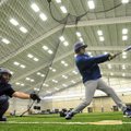 Rogers High senior Alex Shelor takes batting practice with junior catcher Jake Rylee behind the plat...