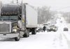 Motorists try to avoid stalled traffic on Interstate 540 by cutting through Lowell but are themselves stalled when a tractor trailer fails to climb the grade approaching U.S. Highway 71 in Lowell Friday.