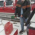 Bennie Smith of Rogers stocks up on kerosene for a heater on Friday at Jiffy Kwick in downtown Roger...