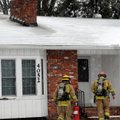 Springdale firefighters enter a home at 4052 Elm Springs Road to fight a flu fire Friday in Springda...