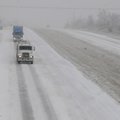 Traffic moves along the southbound land of Interstate 540 Friday as heavy snow begins to fall. Overn...